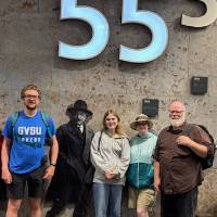 Group shot of faculty and students with a cardboard cutout of Albert Einstein